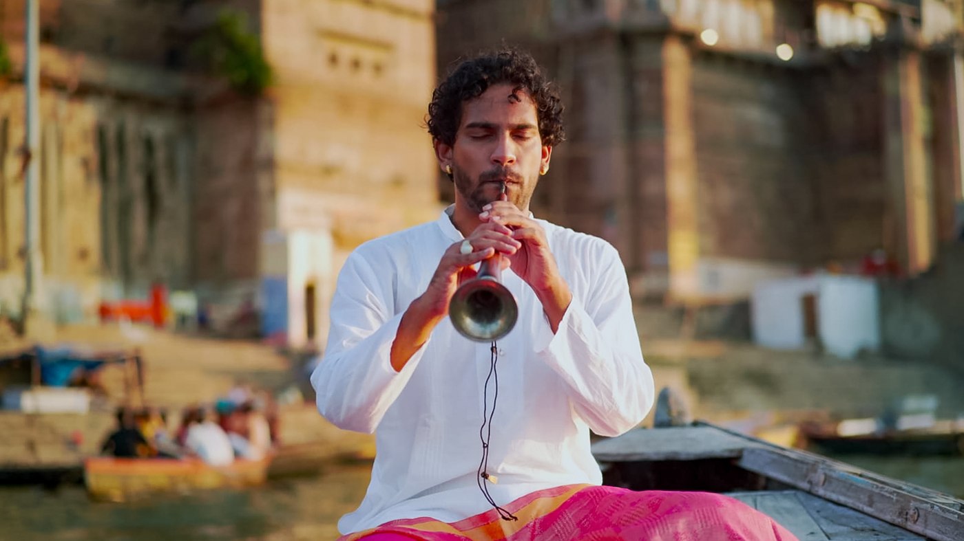 Omkar Dhumal playing the Shehnai on a boat in Banaras